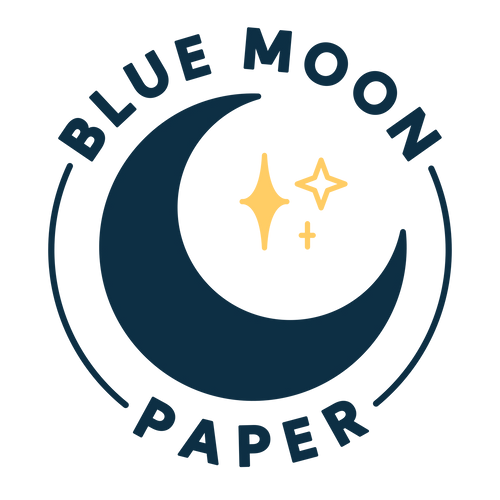 A blue crescent moon with 3 yellow stars filling the empty space of the moon. "Blue Moon Paper" surrounds the moon in a circle, in all caps.