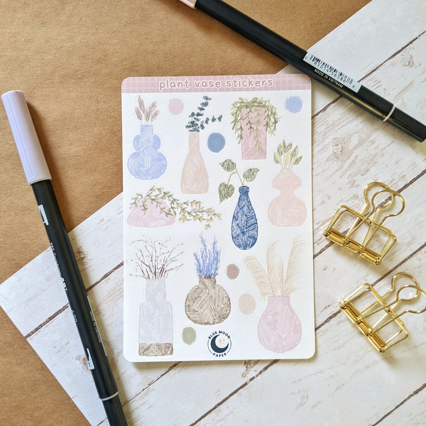 Sticker sheet featuring sketchy illustrations of various plants in vases and pots, and surrounded by dots of colour.