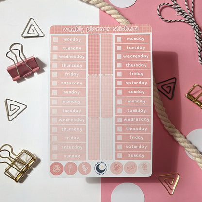 Pink sticker sheet with the days of the week on it, rectangles, and dots with floral illustrations.