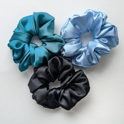 Teal, light blue, and black scrunchies.