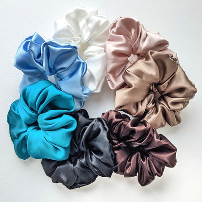 A set of large satin scrunchies in various colours, arranged to make a circle.